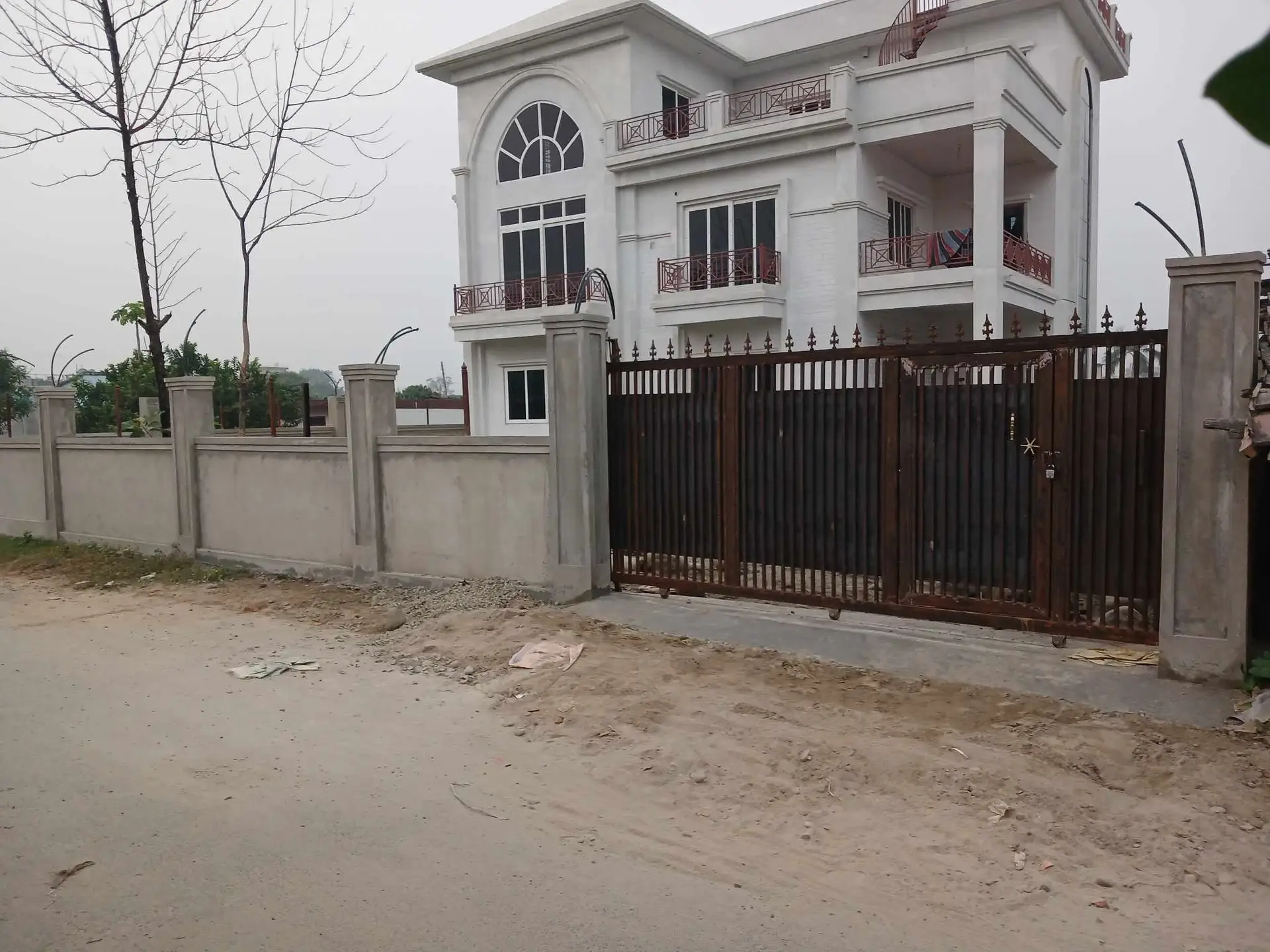 Arched-Window Residence: Completed family house with arched windows, built by HNG in Nepal, image 2 of 3