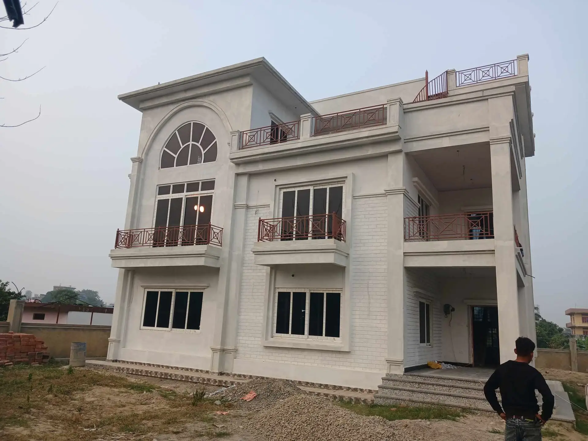 Arched-Window Residence: Completed family house with arched windows, built by HNG in Nepal, image 3 of 3